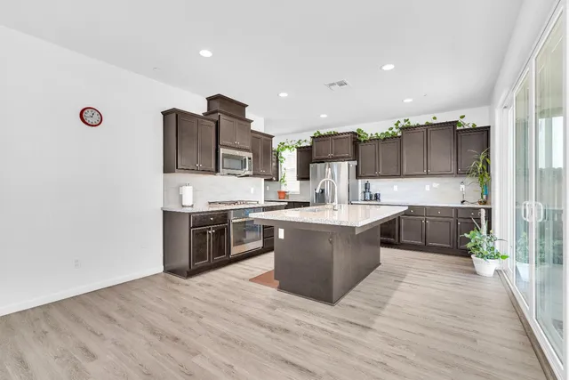 a kitchen with a stove sink and refrigerator