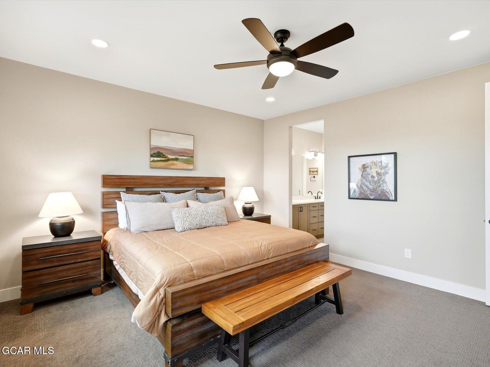 95 River Run Circle Fraser, CO 80442 - Photo 40 of 66 a bedroom with a bed and a ceiling fan