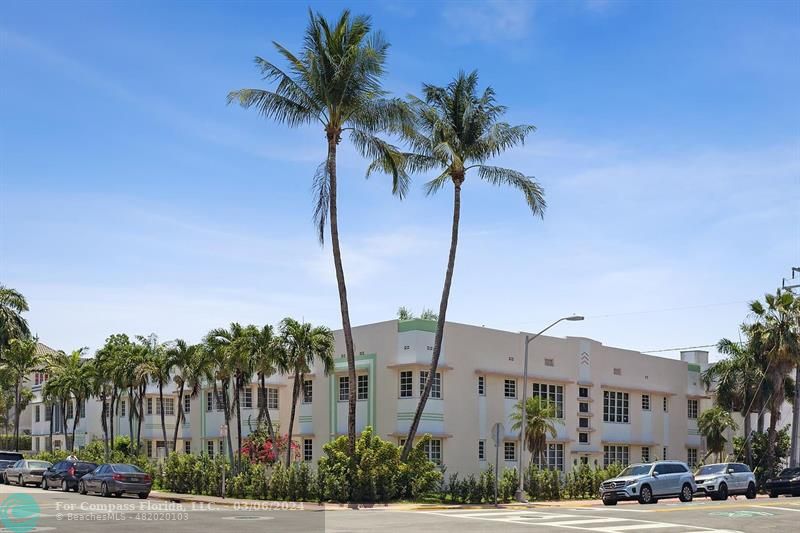 a front view of multiple houses with palm trees