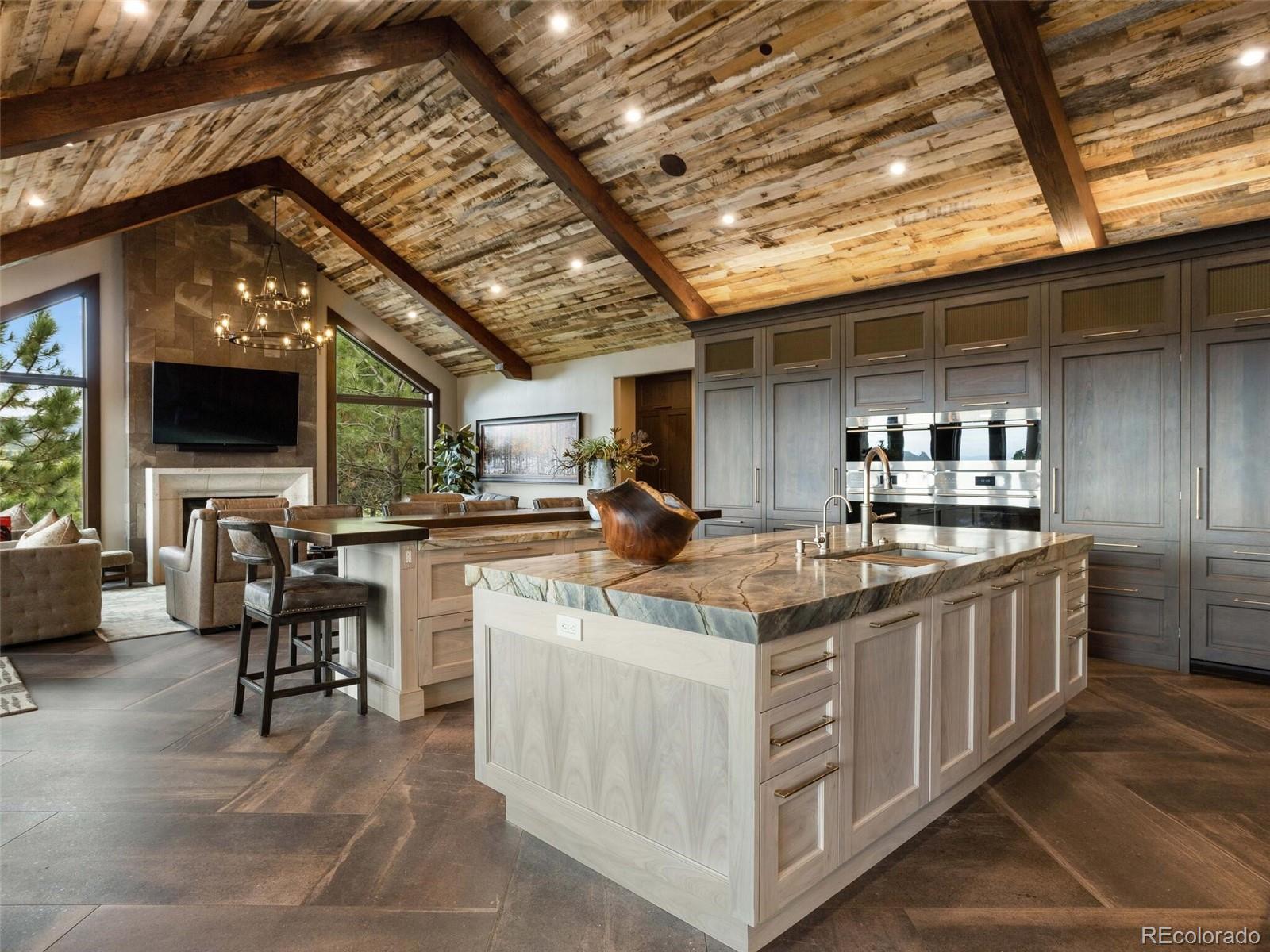 1395 Waverton Ranch Road Castle Rock, CO 80109 - Photo 11 of 40 a kitchen with stainless steel appliances granite countertop a sink and cabinets