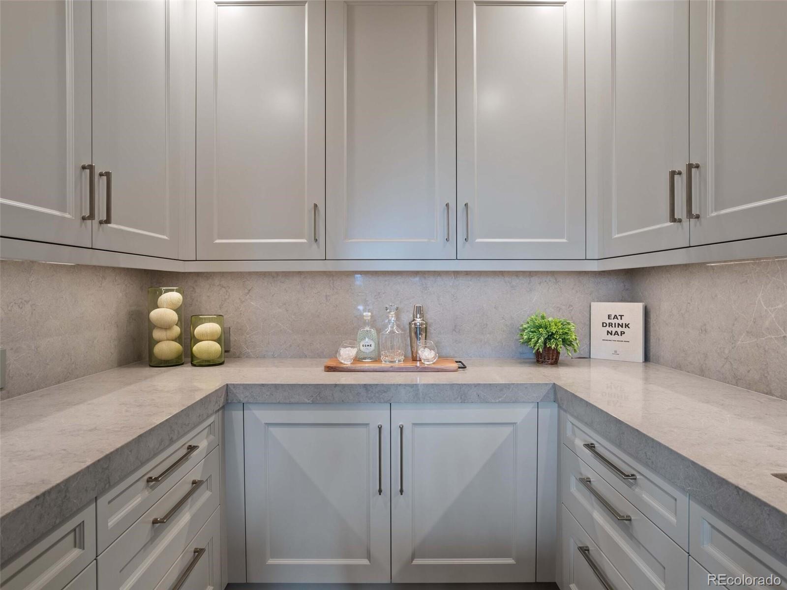 1395 Waverton Ranch Road Castle Rock, CO 80109 - Photo 15 of 40 a kitchen with granite countertop white cabinets and wooden cabinets