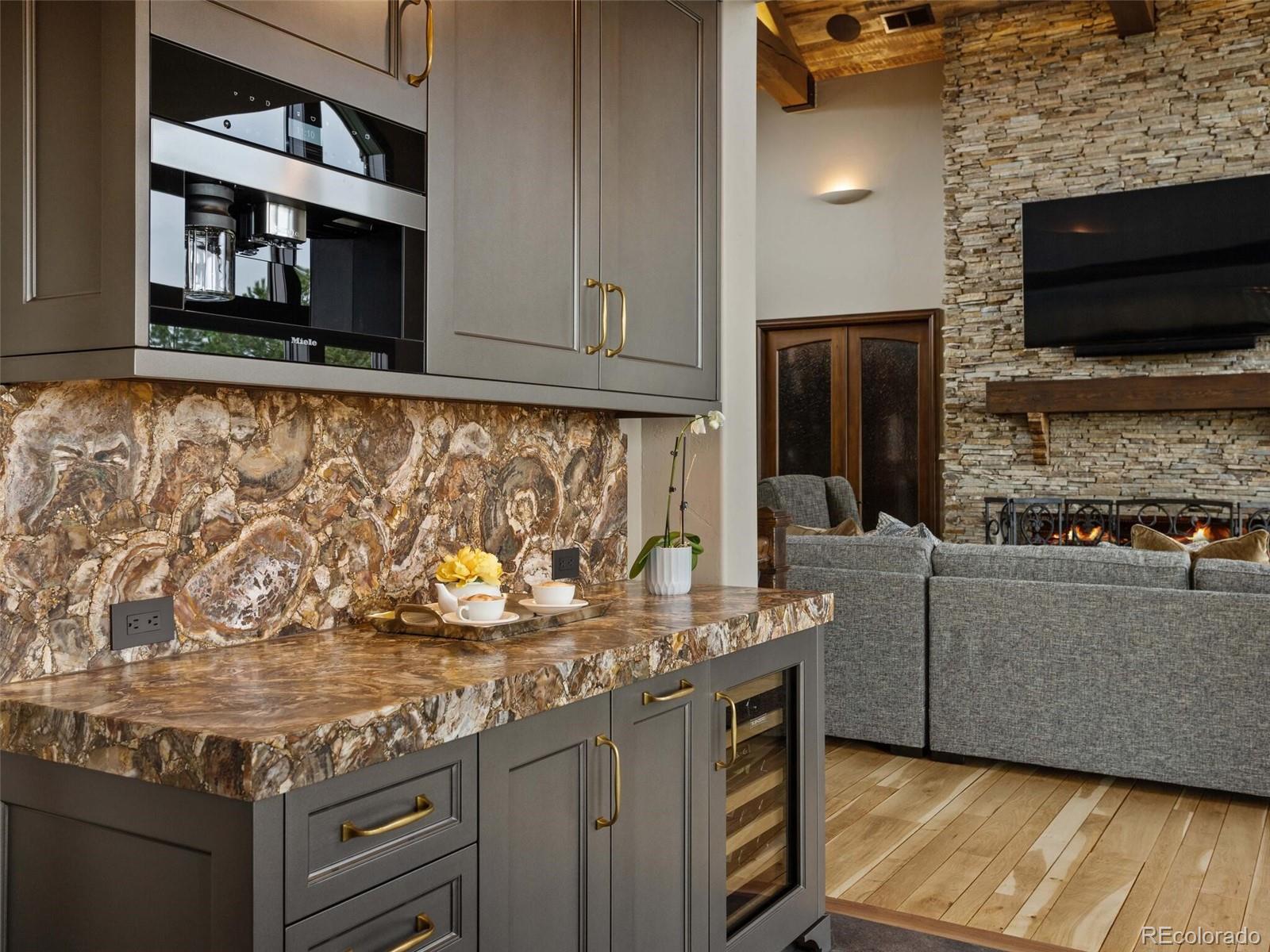 1395 Waverton Ranch Road Castle Rock, CO 80109 - Photo 17 of 40 a living room with fireplace furniture and a flat screen tv