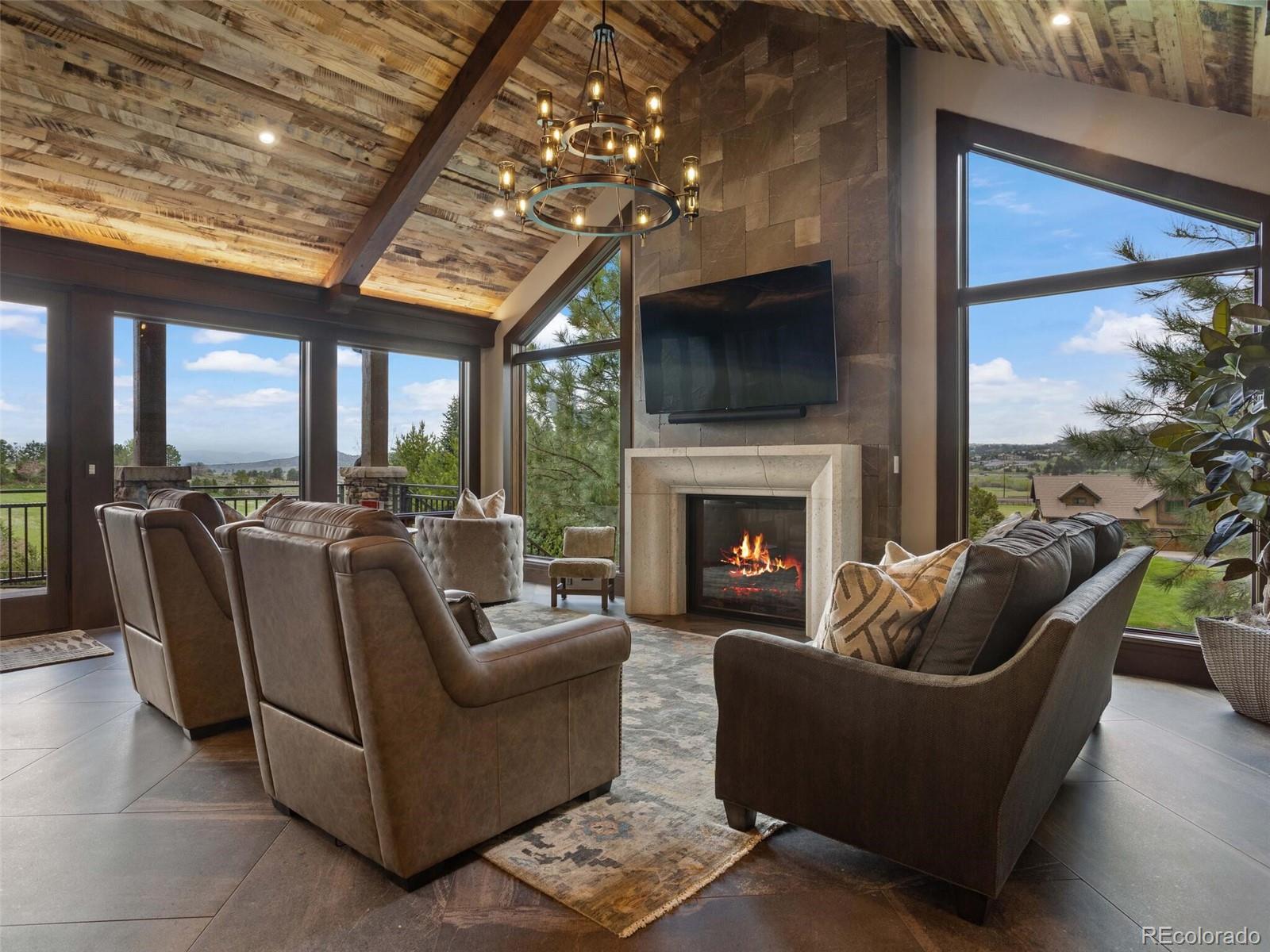1395 Waverton Ranch Road Castle Rock, CO 80109 - Photo 18 of 40 a living room with furniture and a fireplace
