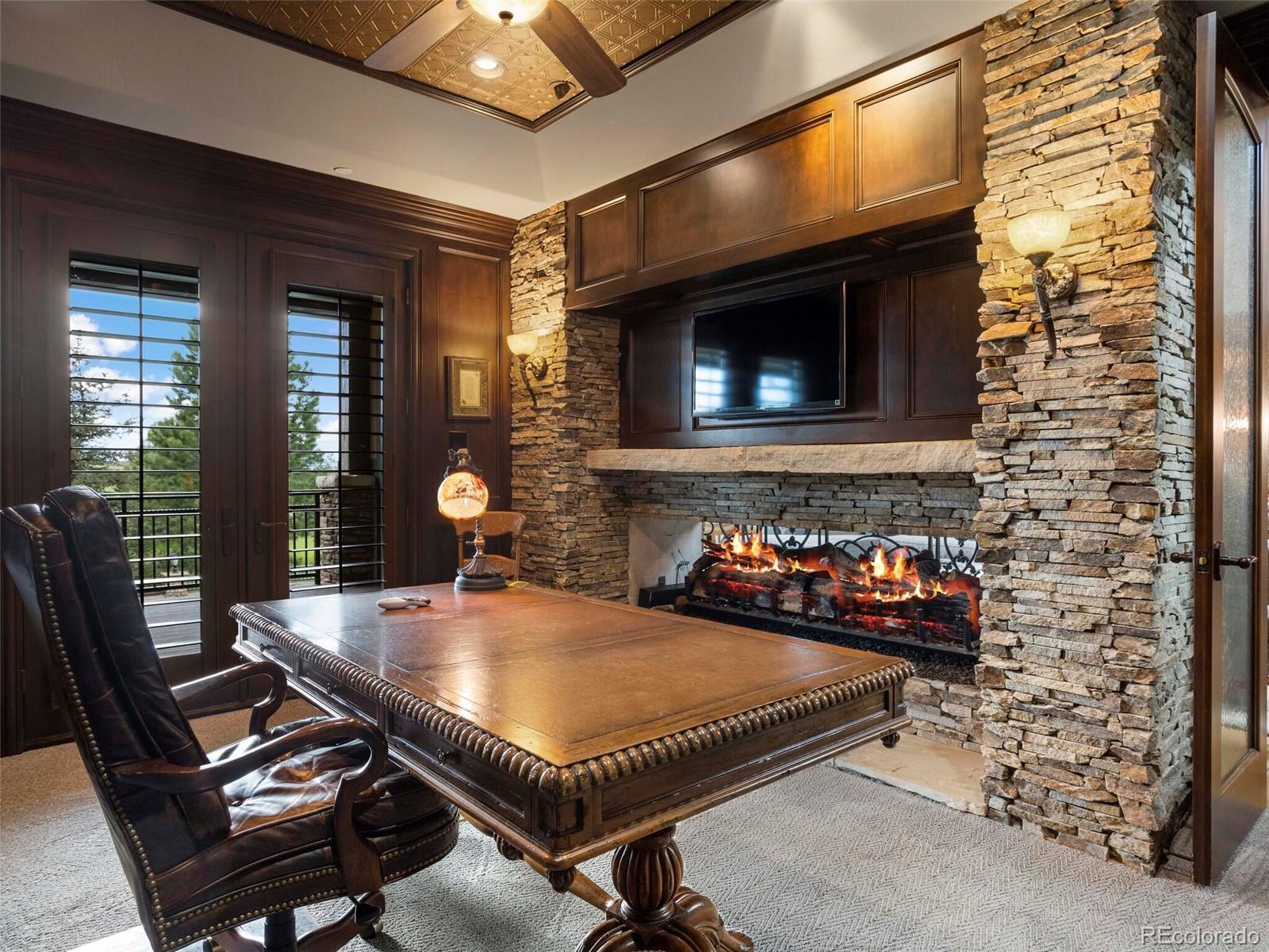1395 Waverton Ranch Road Castle Rock, CO 80109 - Photo 21 of 40 a living room with furniture a flat screen tv and a fireplace