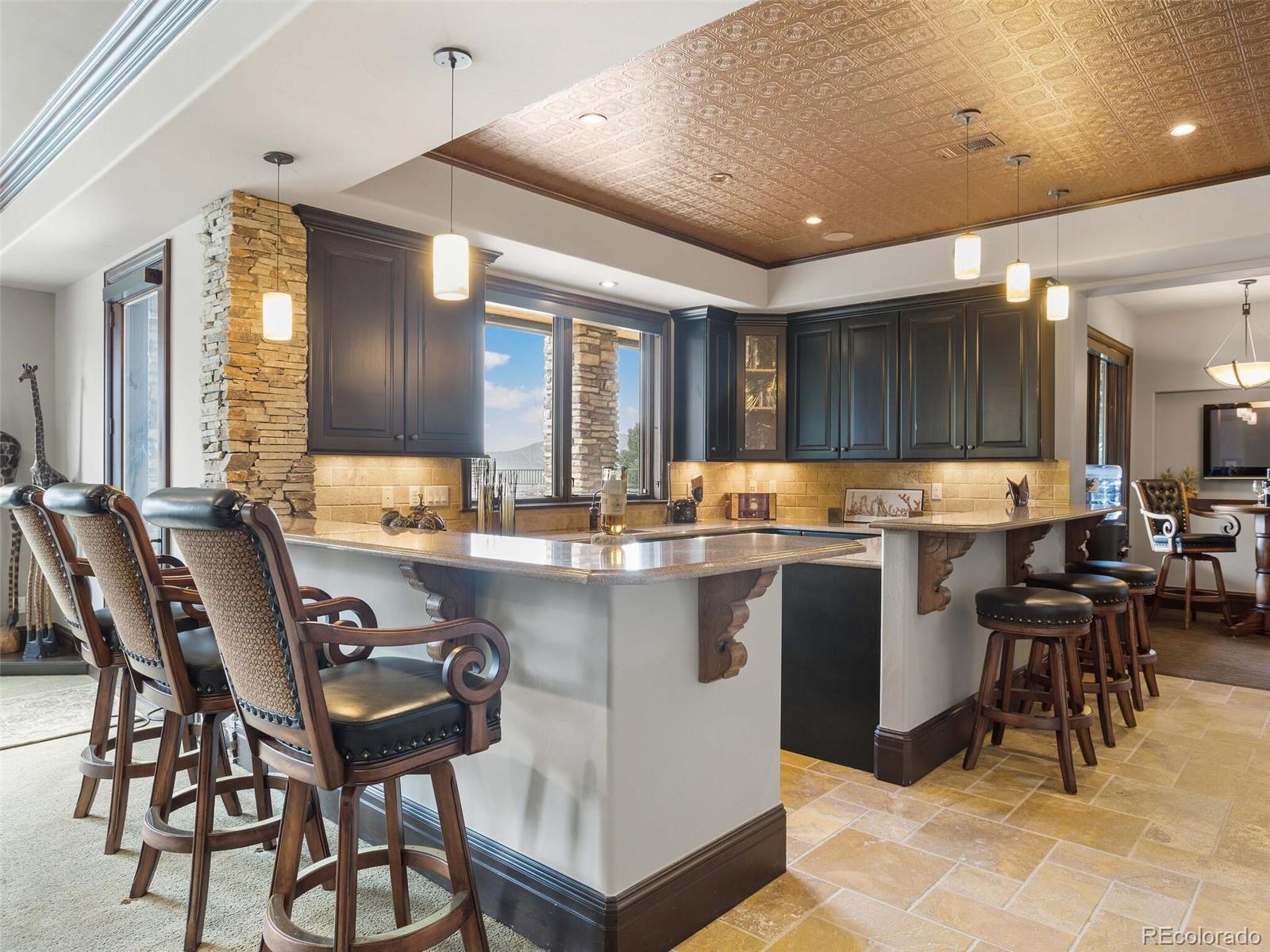 1395 Waverton Ranch Road Castle Rock, CO 80109 - Photo 25 of 40 a kitchen with lots of counter top space and dining table