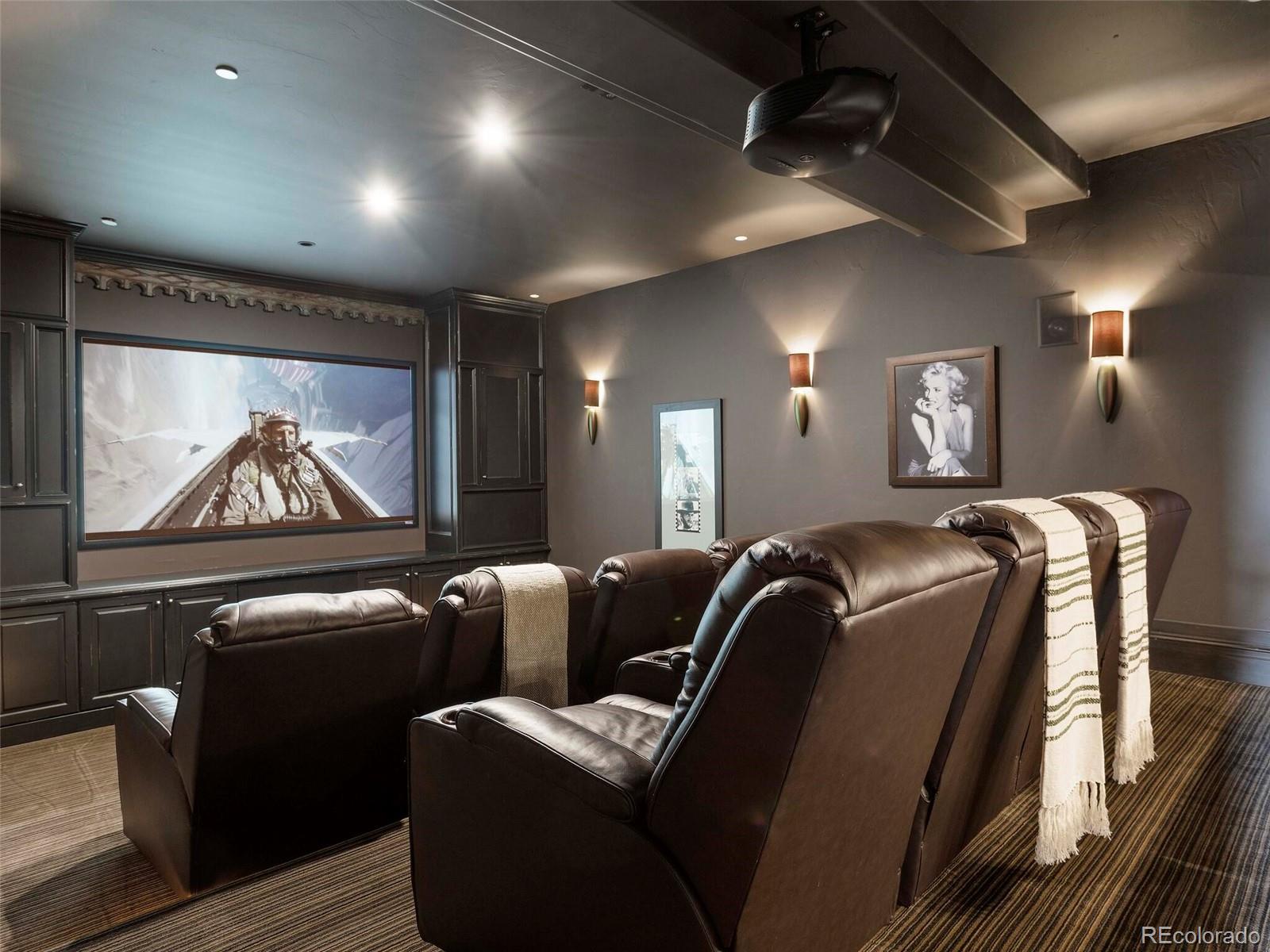 1395 Waverton Ranch Road Castle Rock, CO 80109 - Photo 26 of 40 a media room with lots of chairs and a projector