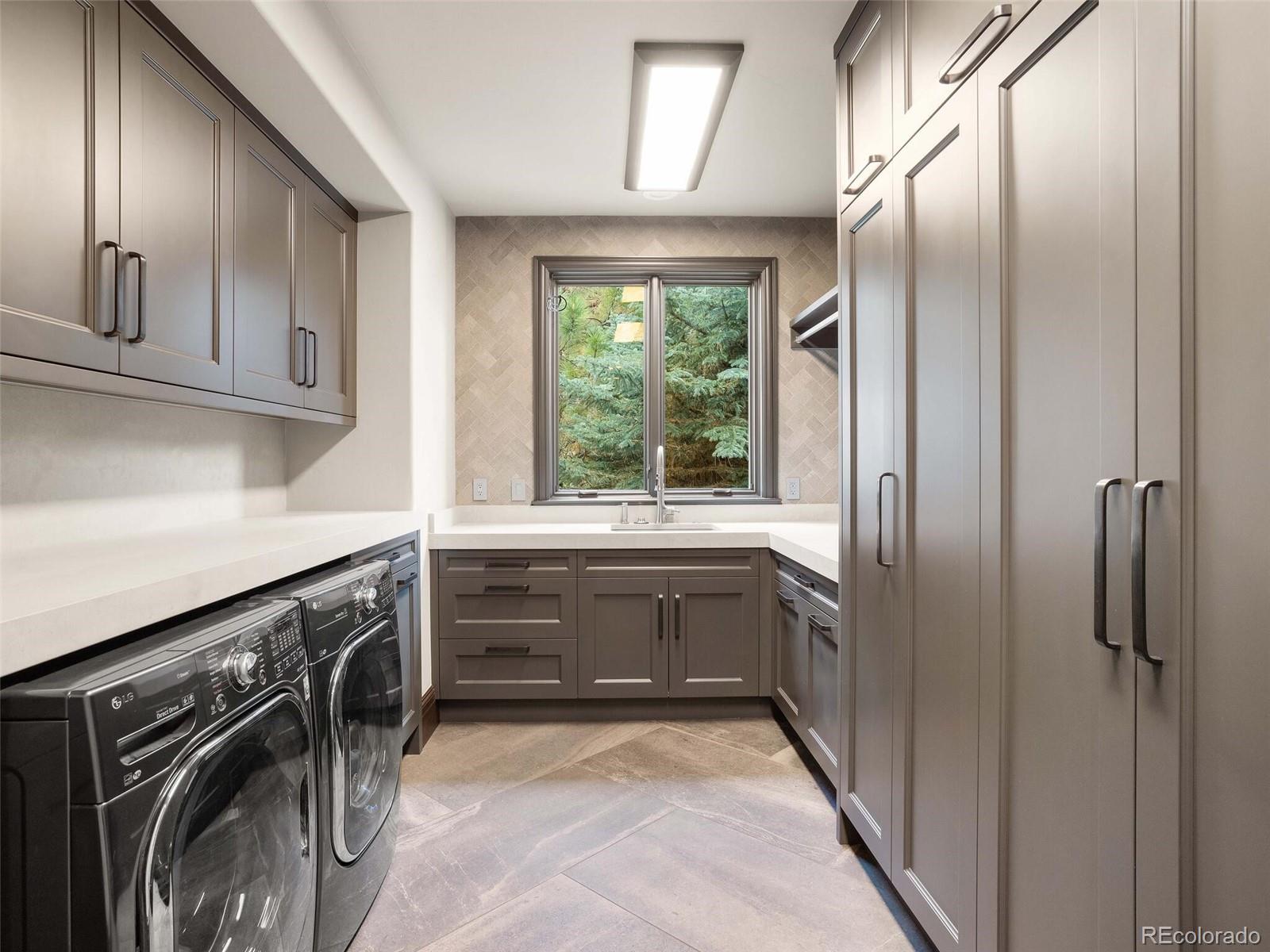 1395 Waverton Ranch Road Castle Rock, CO 80109 - Photo 29 of 40 a kitchen with granite countertop a refrigerator and a sink