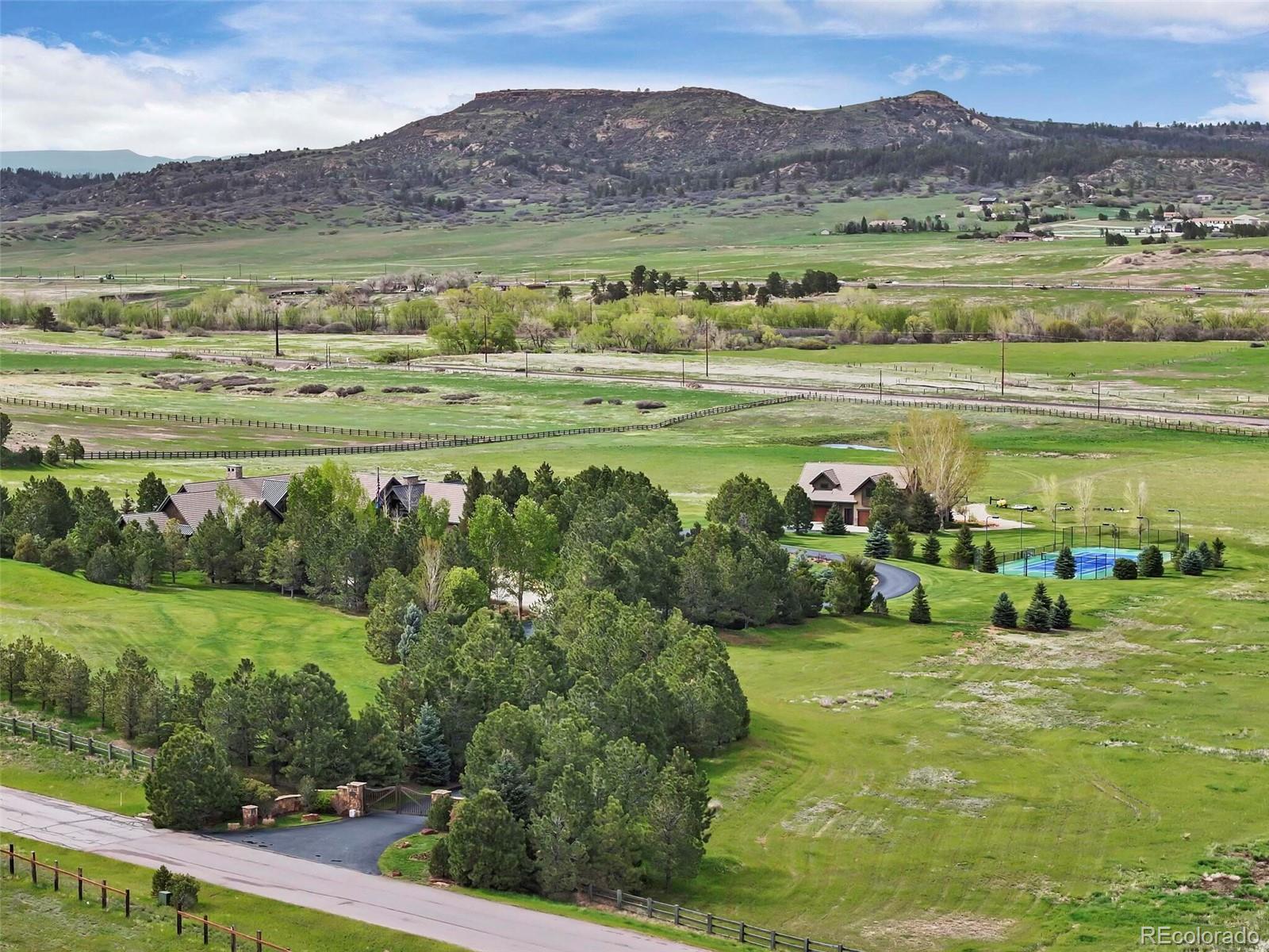 1395 Waverton Ranch Road Castle Rock, CO 80109 - Photo 3 of 40 a view of a lush green hillside and houses