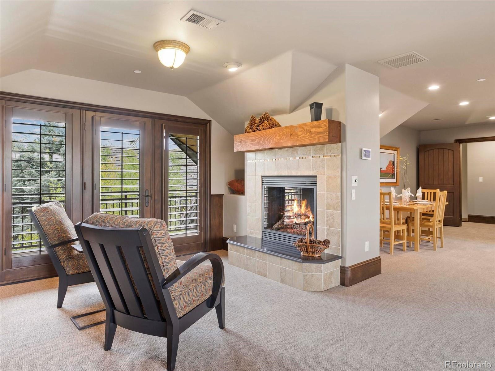 1395 Waverton Ranch Road Castle Rock, CO 80109 - Photo 32 of 40 a living room with furniture and a fireplace