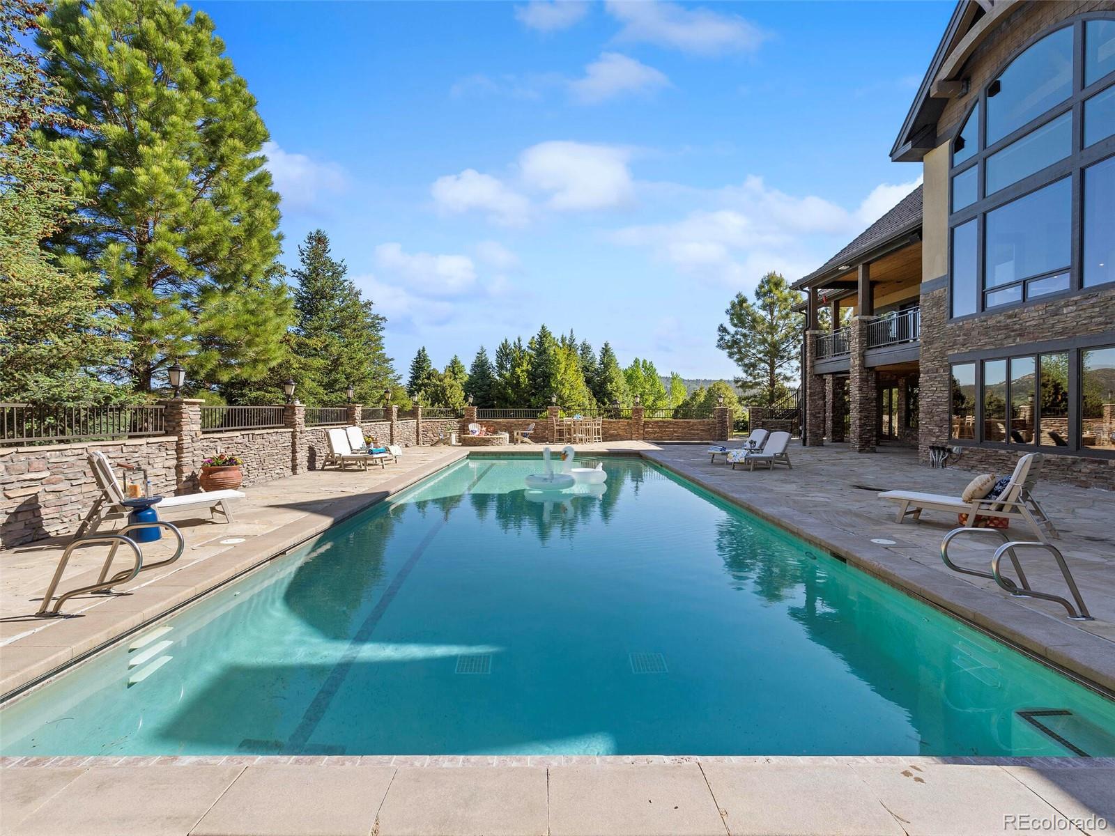 1395 Waverton Ranch Road Castle Rock, CO 80109 - Photo 33 of 40 a view of swimming pool with outdoor seating and lake view