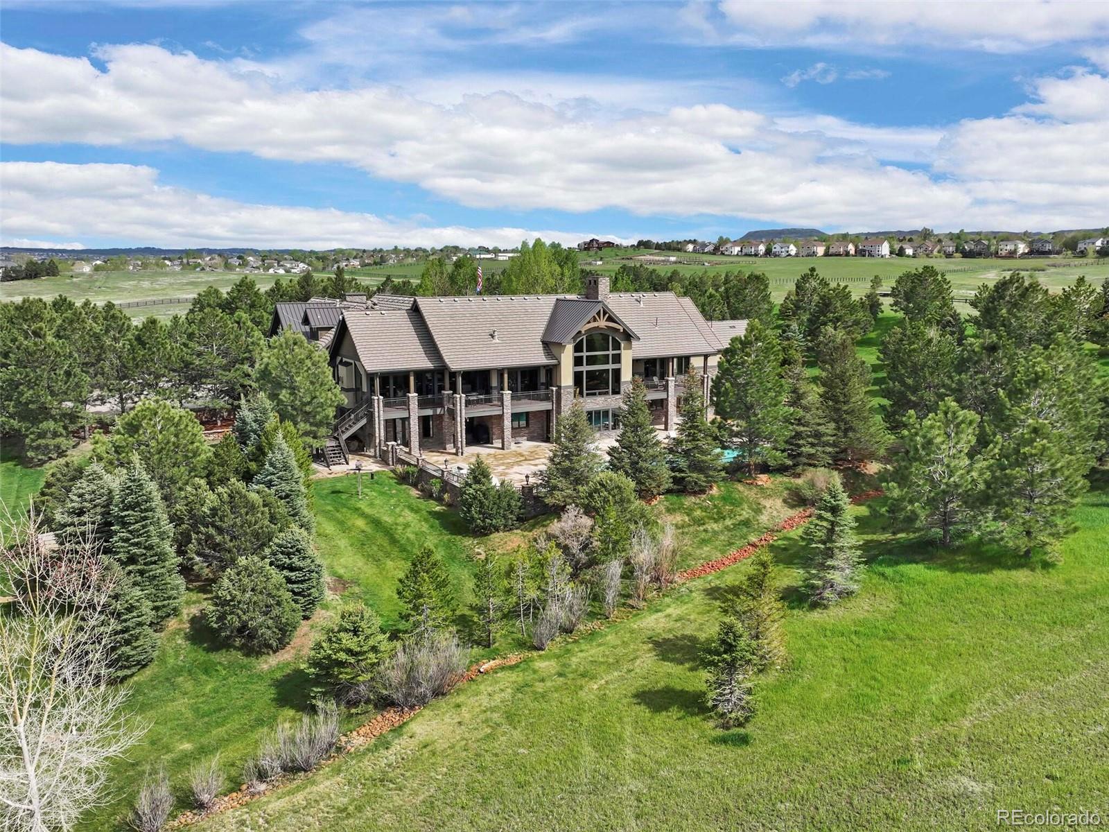 1395 Waverton Ranch Road Castle Rock, CO 80109 - Photo 34 of 40 a view of a big yard with swimming pool and green space