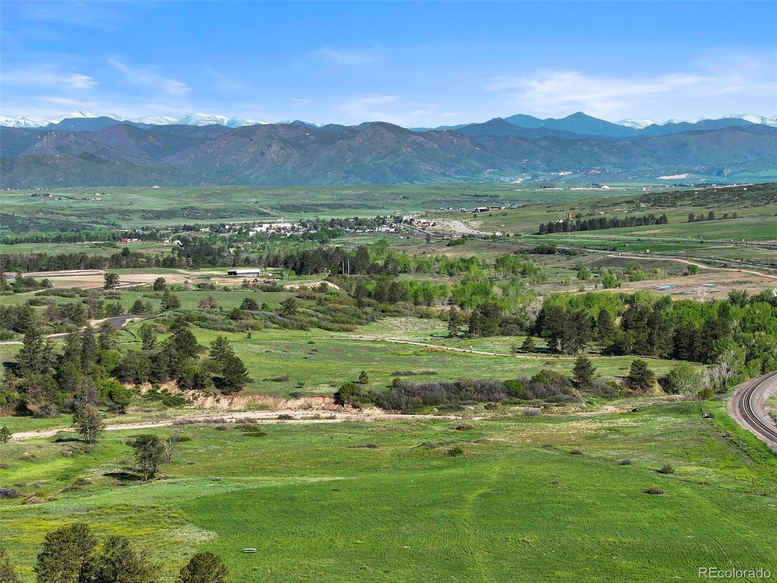 1395 Waverton Ranch Road Castle Rock, CO 80109 - Photo 37 of 40 a view of a lush green hillside and houses