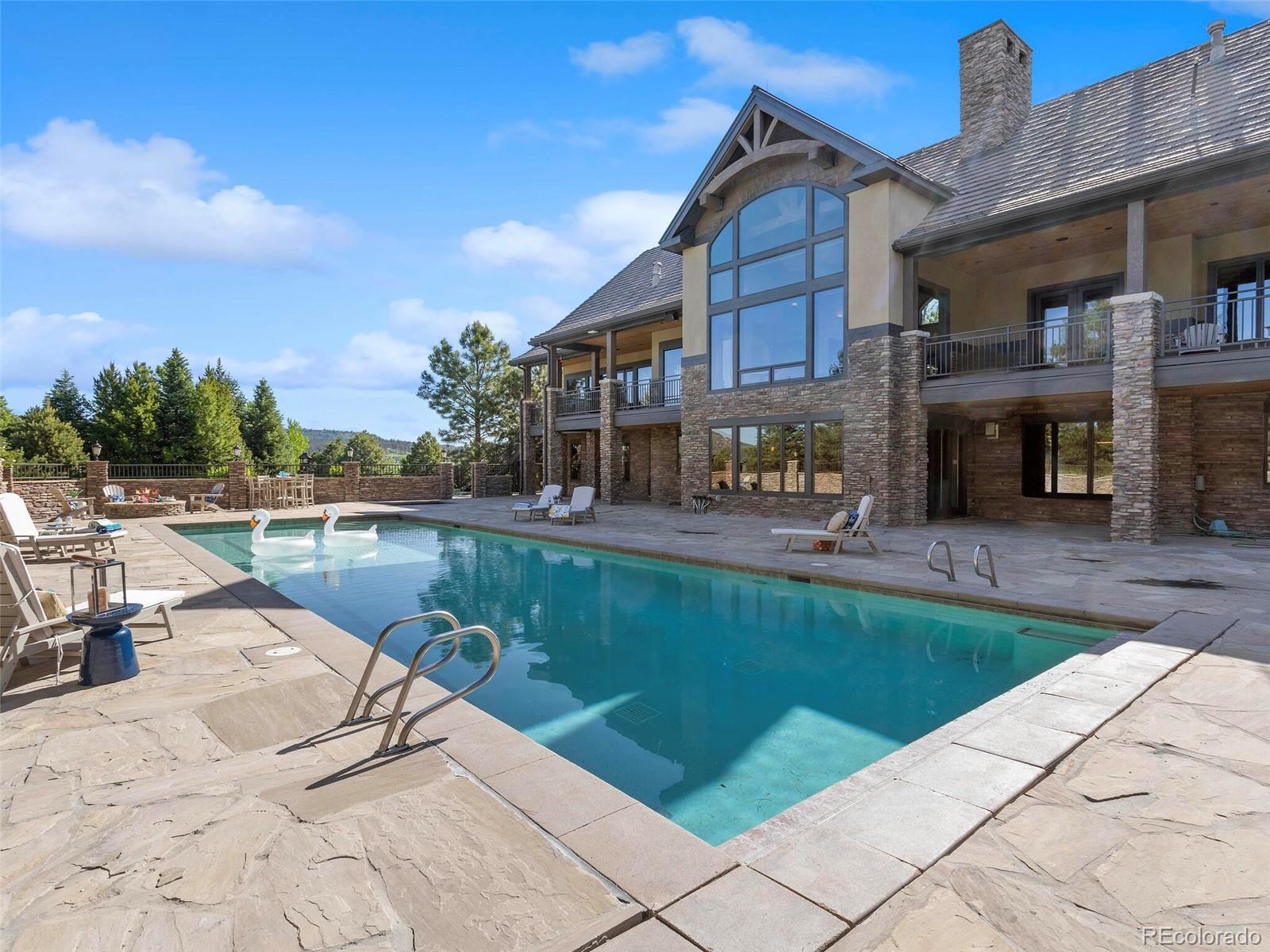 1395 Waverton Ranch Road Castle Rock, CO 80109 - Photo 4 of 40 a view of a swimming pool with a lounge chairs