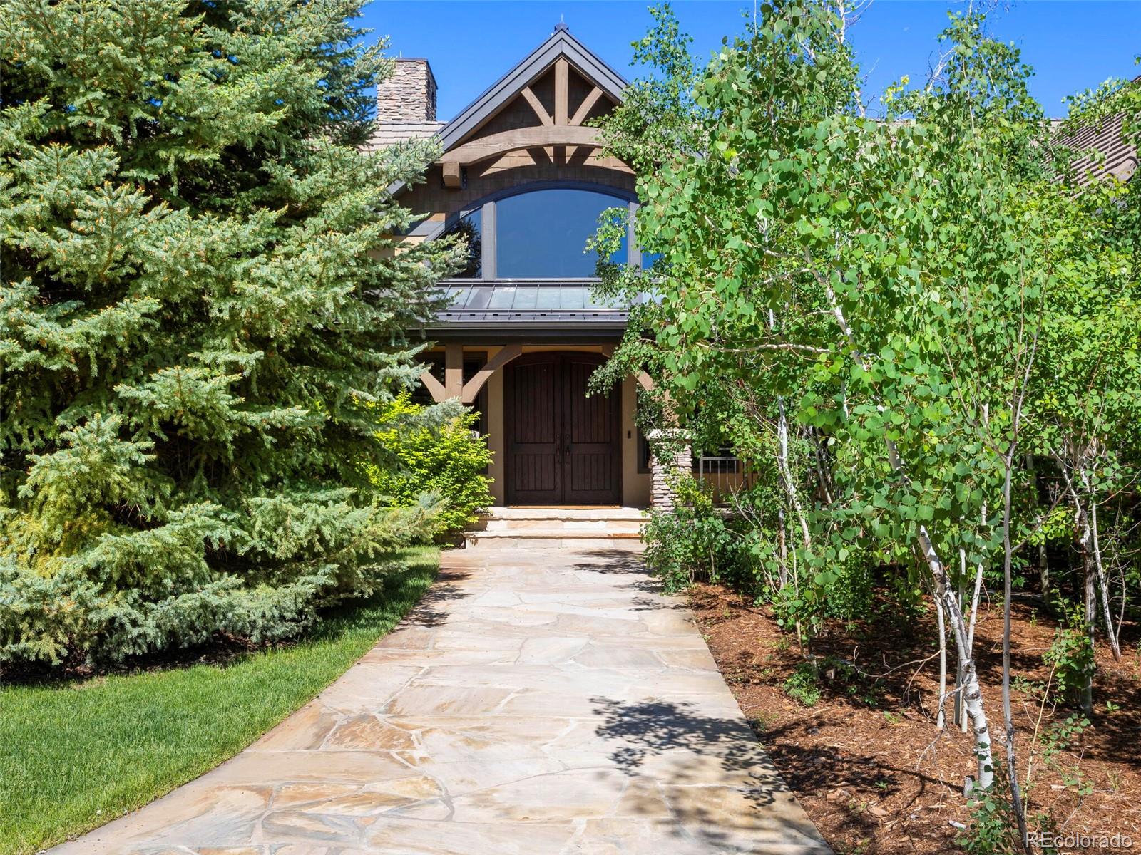 1395 Waverton Ranch Road Castle Rock, CO 80109 - Photo 6 of 40 a front view of a house with a garden