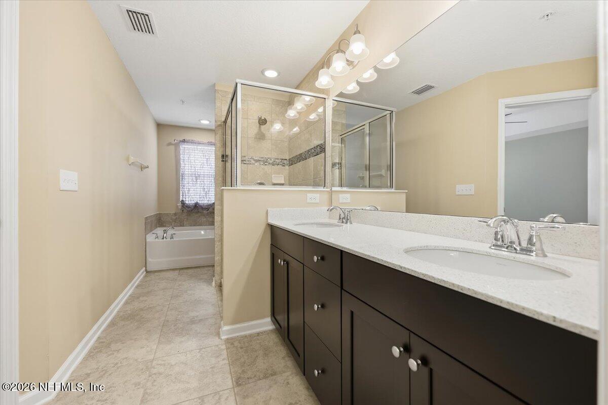 148 Paradas Place St. Augustine, FL 32092 - Photo 11 of 24 a bathroom with a double vanity sink mirror and shower