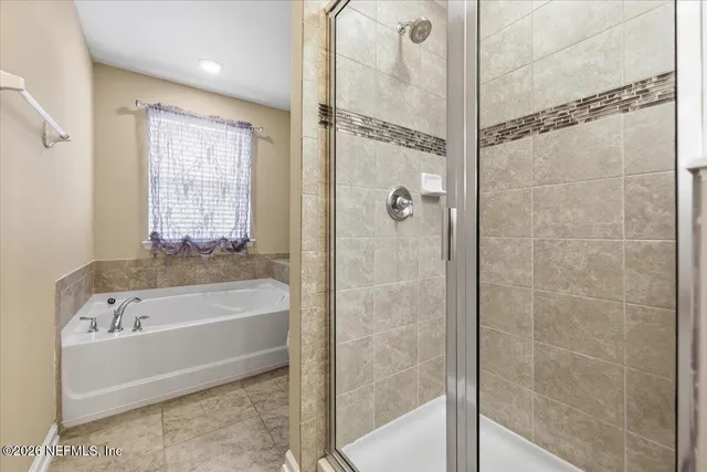 a bathroom with a bathtub and a shower