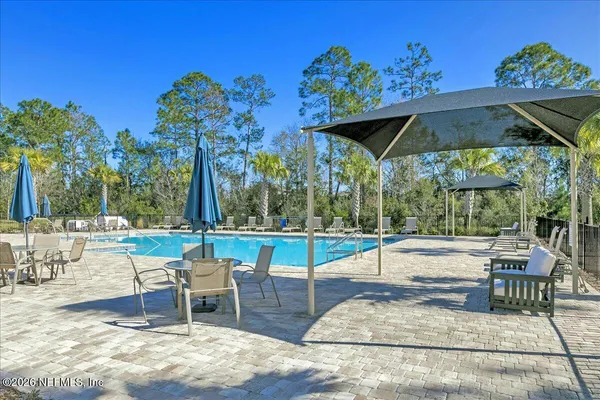 swimming pool view with a seating space