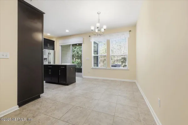 a spacious bathroom with a granite countertop sink a large mirror and a shower