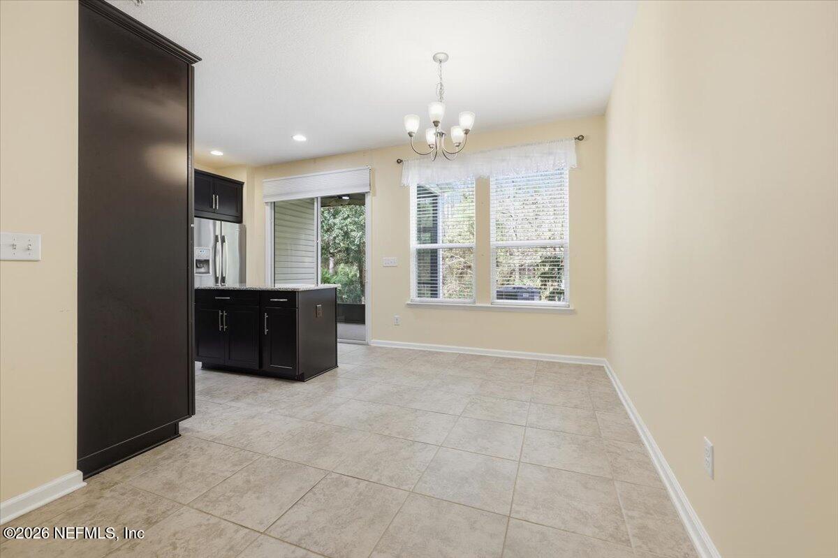 148 Paradas Place St. Augustine, FL 32092 - Photo 7 of 24 a spacious bathroom with a granite countertop sink a large mirror and a shower