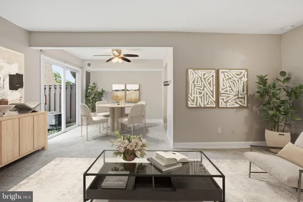 a living room with furniture a chandelier and a dining table