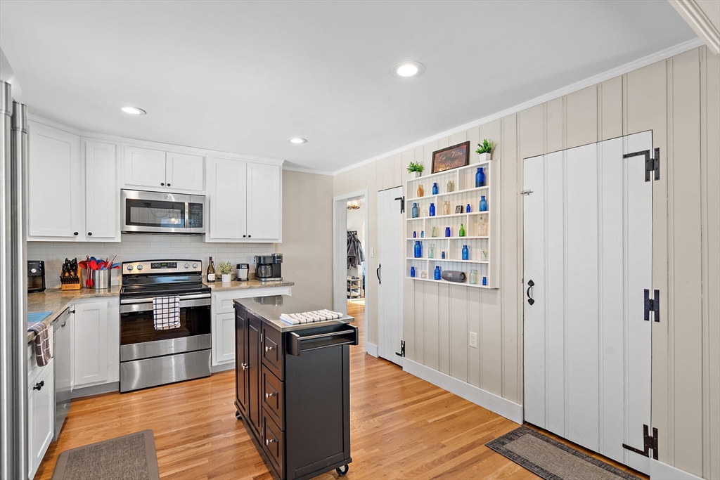 1190 Liberty Square Road Boxborough, MA 01719 - Photo 11 of 24 a kitchen with stainless steel appliances granite countertop a refrigerator oven a sink dishwasher and white cabinets with wooden floor