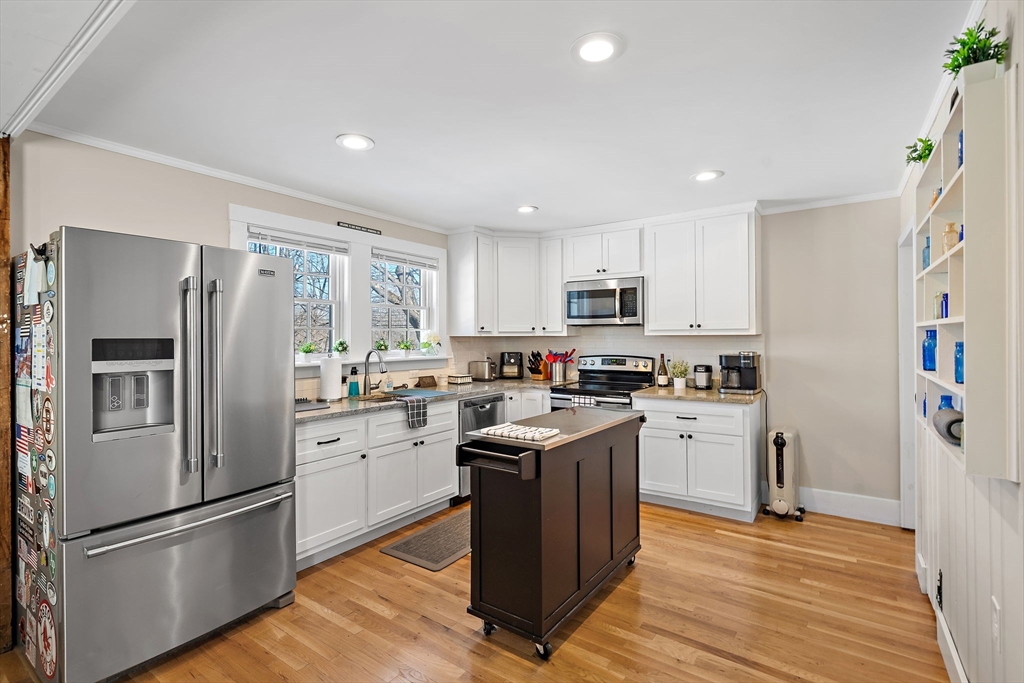 1190 Liberty Square Road Boxborough, MA 01719 - Photo 12 of 24 a kitchen with stainless steel appliances granite countertop a refrigerator stove a sink and a oven with wooden floor