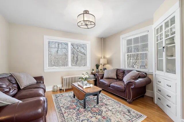 a bedroom with furniture and a large window