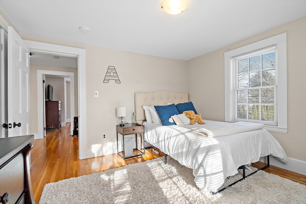 1190 Liberty Square Road Boxborough, MA 01719 - Photo 18 of 24 a bedroom with a bed and wooden floor