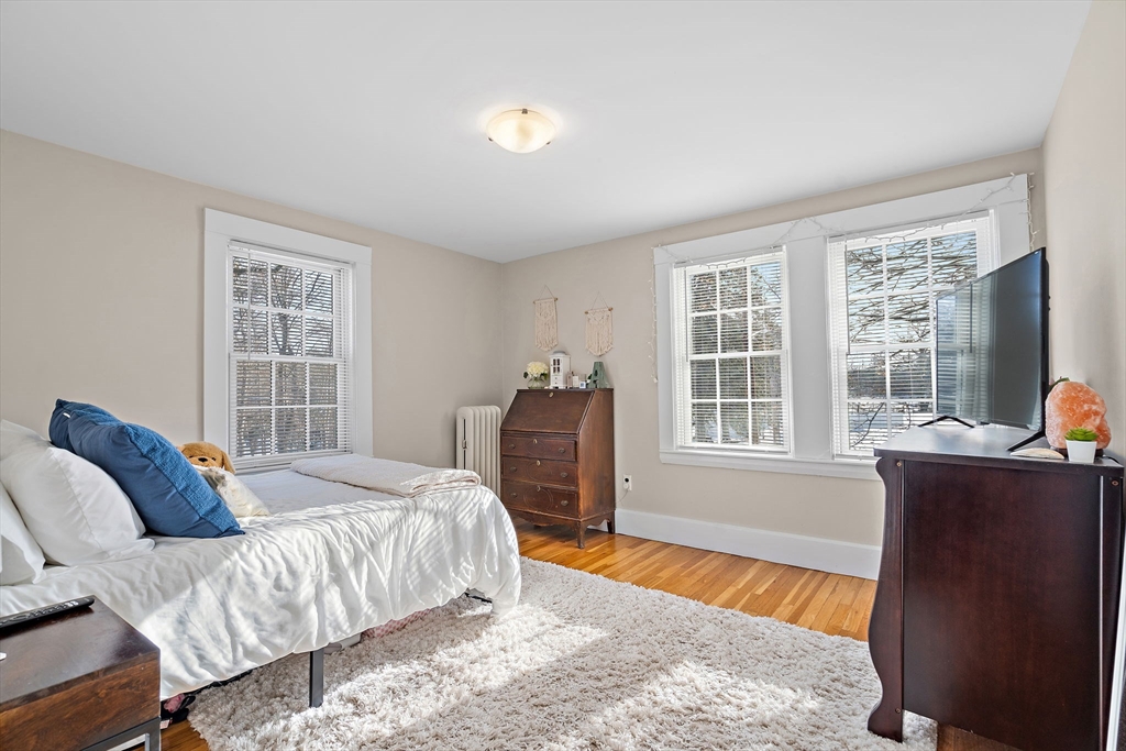 1190 Liberty Square Road Boxborough, MA 01719 - Photo 19 of 24 a bedroom with a bed and wooden floor