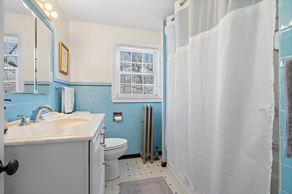 1190 Liberty Square Road Boxborough, MA 01719 - Photo 22 of 24 a bathroom with a sink a toilet and a mirror