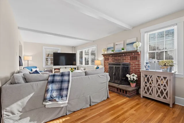 a kitchen with stainless steel appliances granite countertop a refrigerator oven a sink dishwasher and white cabinets with wooden floor