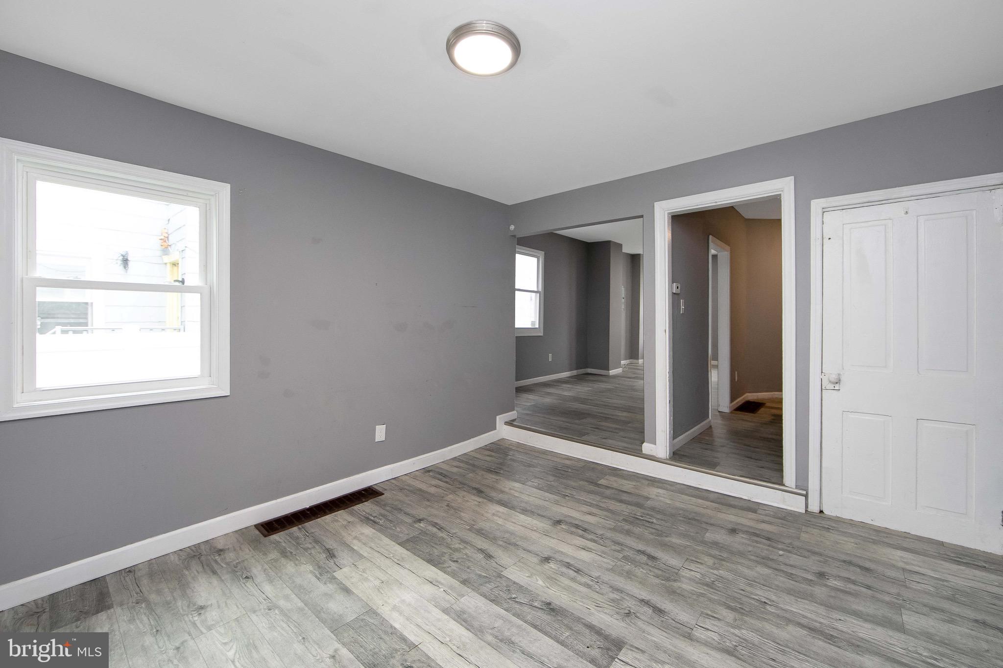 133 East Federal Street Burlington, NJ 08016 - Photo 13 of 43 a view of an empty room with wooden floor and a window