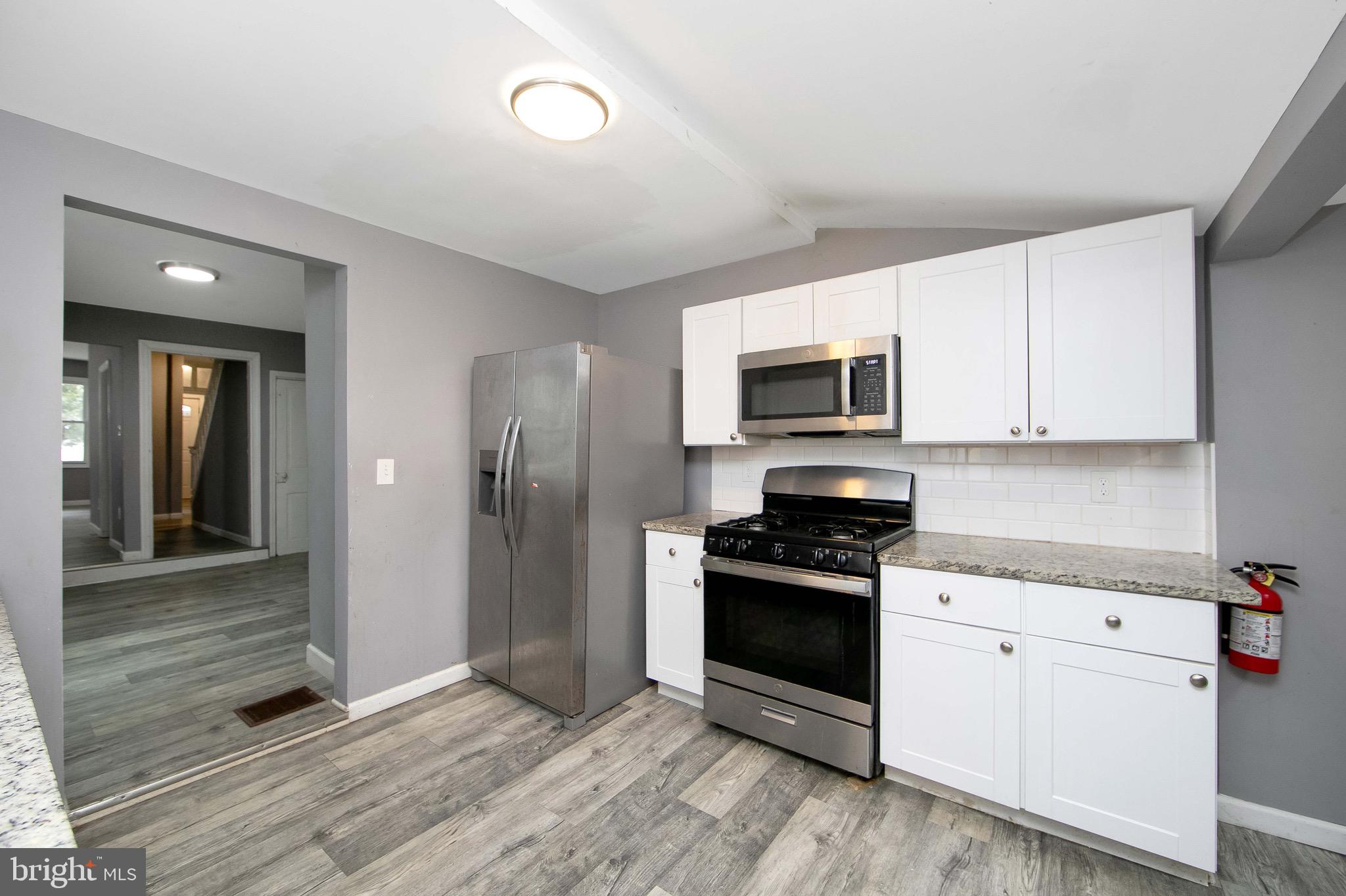 133 East Federal Street Burlington, NJ 08016 - Photo 17 of 43 a kitchen with granite countertop a stove and a sink