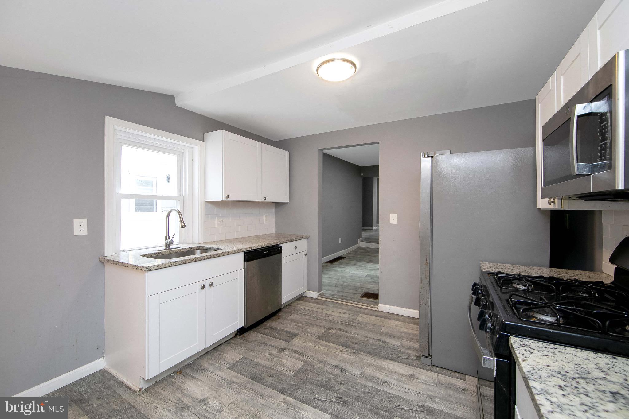 133 East Federal Street Burlington, NJ 08016 - Photo 18 of 43 a kitchen with stainless steel appliances granite countertop a stove and a sink
