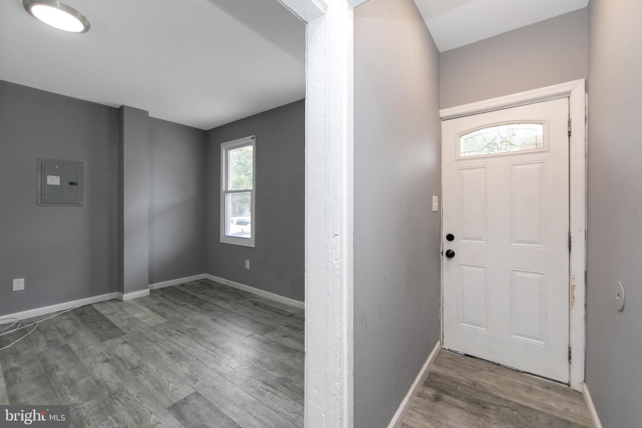133 East Federal Street Burlington, NJ 08016 - Photo 4 of 43 a view of an empty room with window and wooden floor
