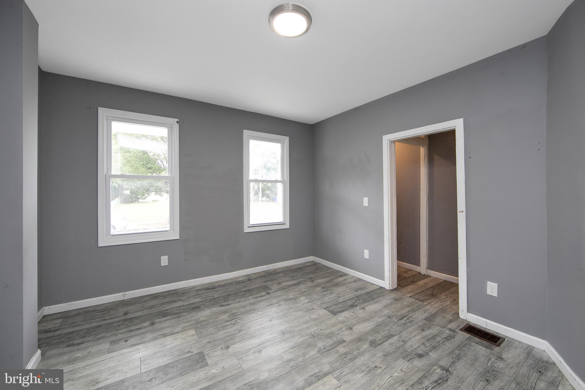 133 East Federal Street Burlington, NJ 08016 - Photo 8 of 43 a view of an empty room with wooden floor and a window