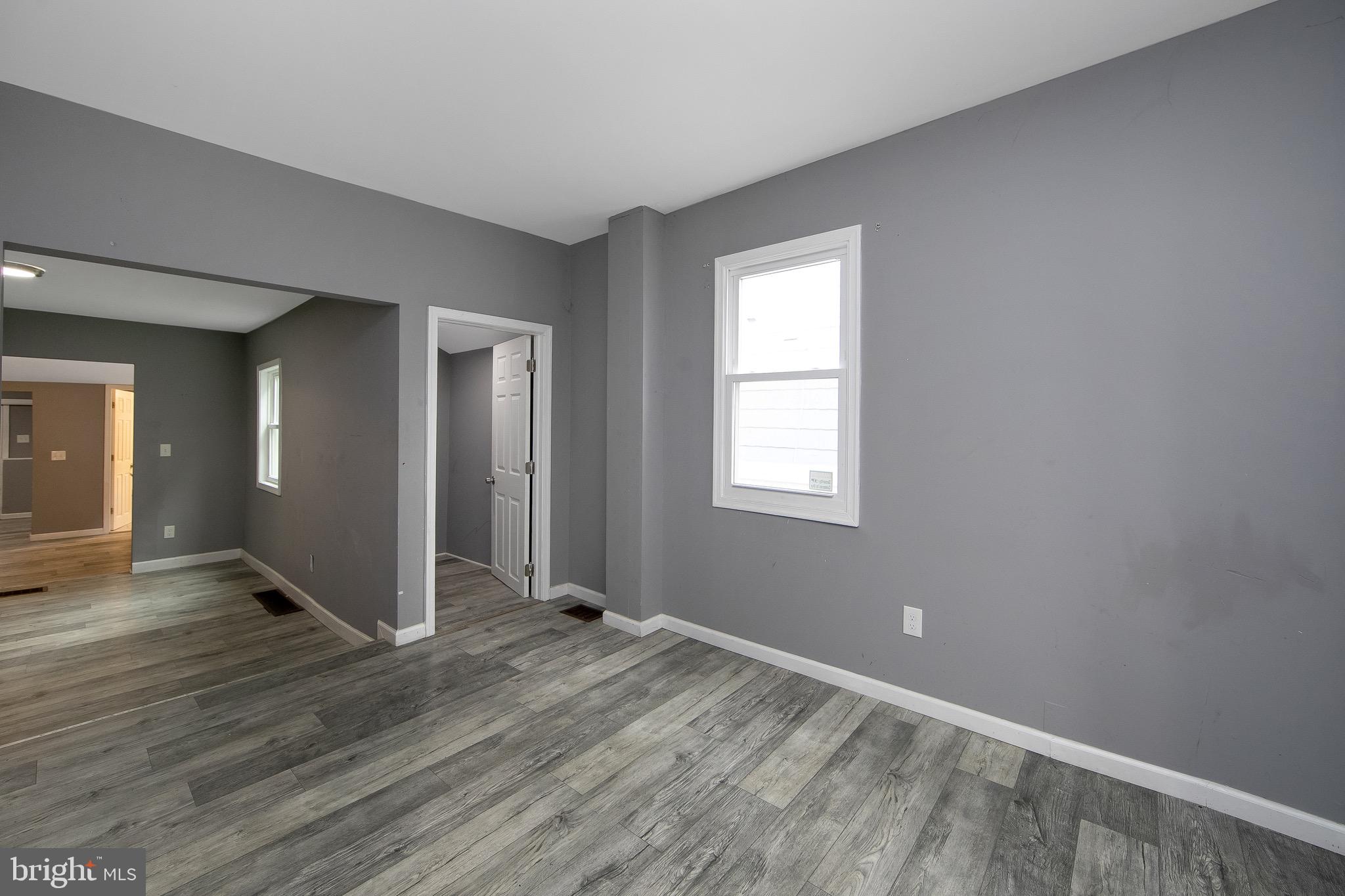 133 East Federal Street Burlington, NJ 08016 - Photo 10 of 43 a view of an empty room with wooden floor and a window
