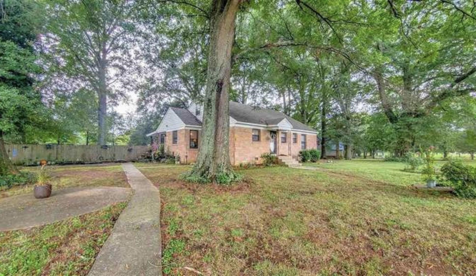 6955 St Elmo Road Memphis, TN 38135 - Photo 1 of 1 a front view of a house with a yard and trees