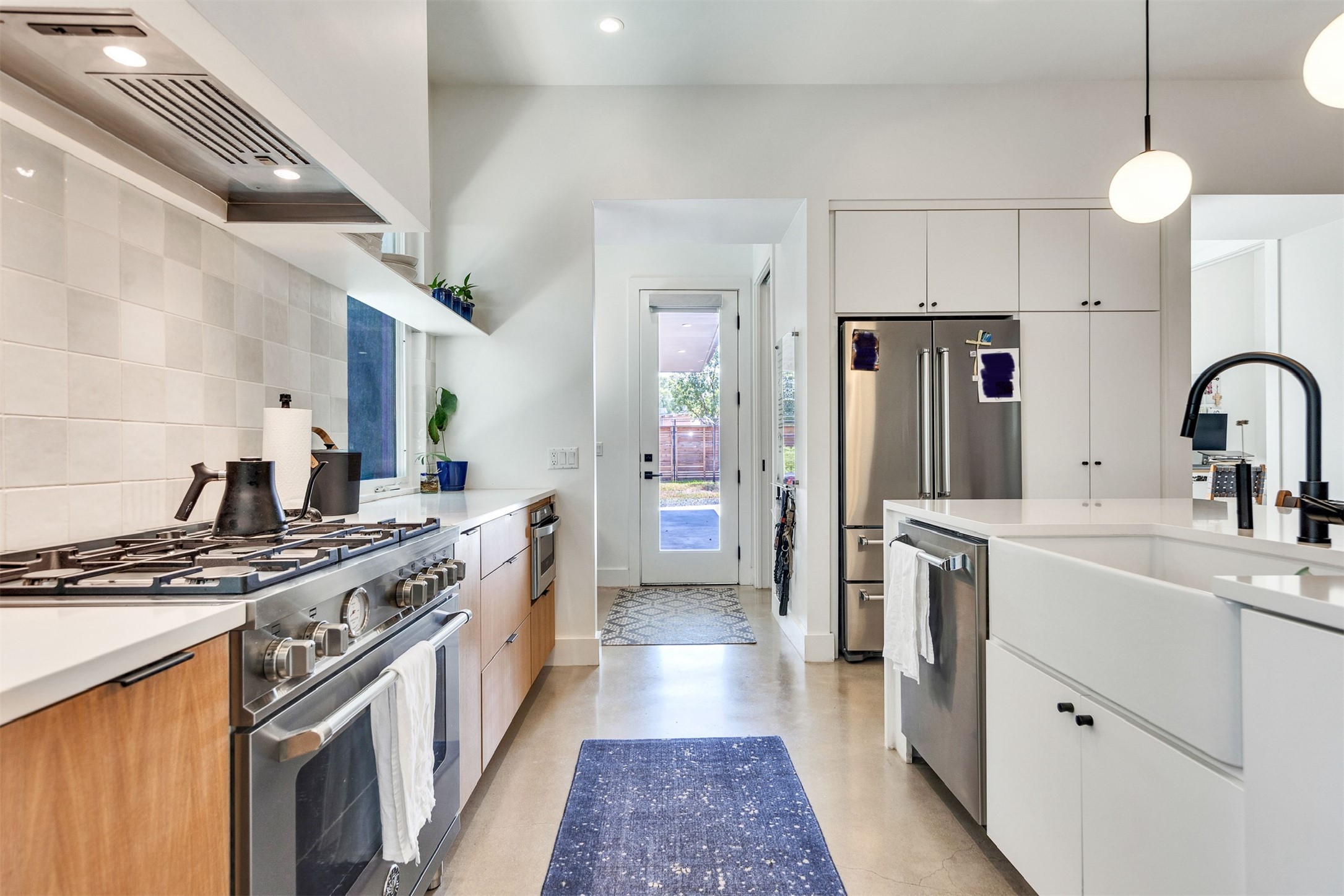 506 Powell Circle Austin, TX 78704 - Photo 17 of 39 a kitchen with stainless steel appliances a sink stove and refrigerator