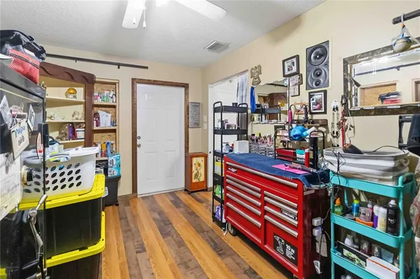 a white house that has tree in front of it