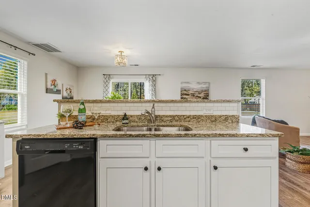 a kitchen with a sink stove and cabinets