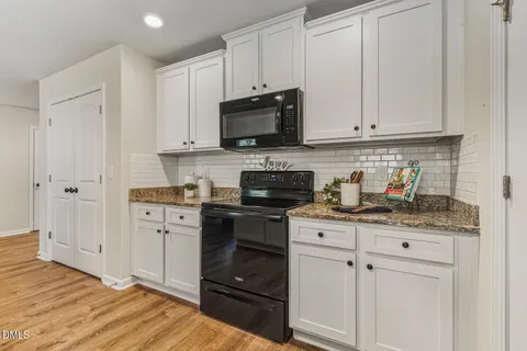 a view of a dining room with furniture a chandelier and wooden floor