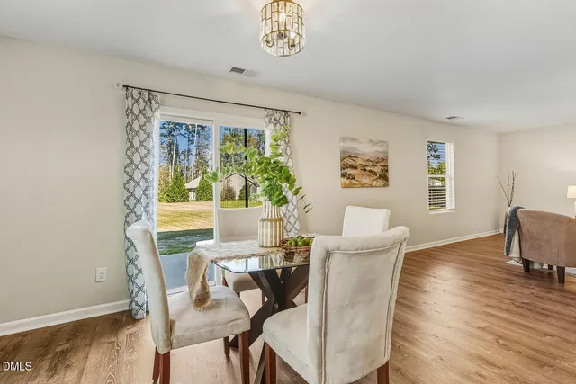 a view of a dining room with furniture window and wooden floor