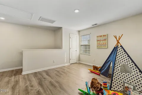 a view of a room with gym equipment and a window