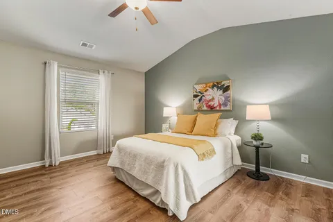 a bedroom with a large bed and a chandelier