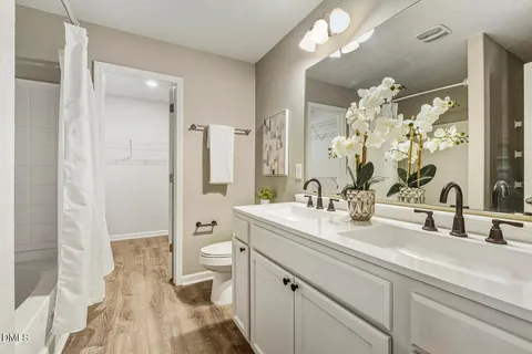 a bathroom with a bathtub toilet and shower