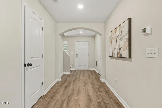 a view of a hallway with wooden floor
