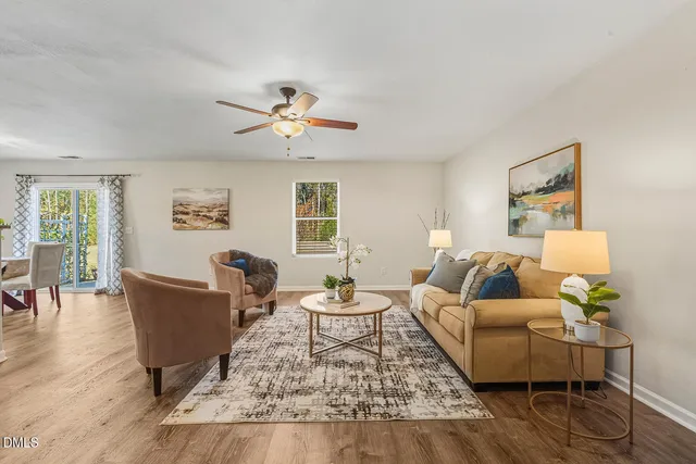 a living room with furniture and wooden floor