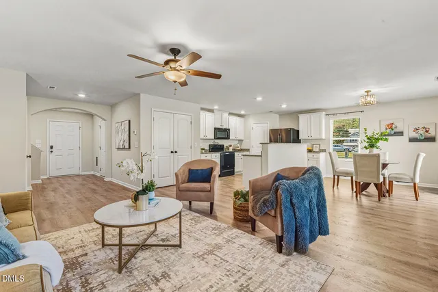 a living room with furniture kitchen view and a table