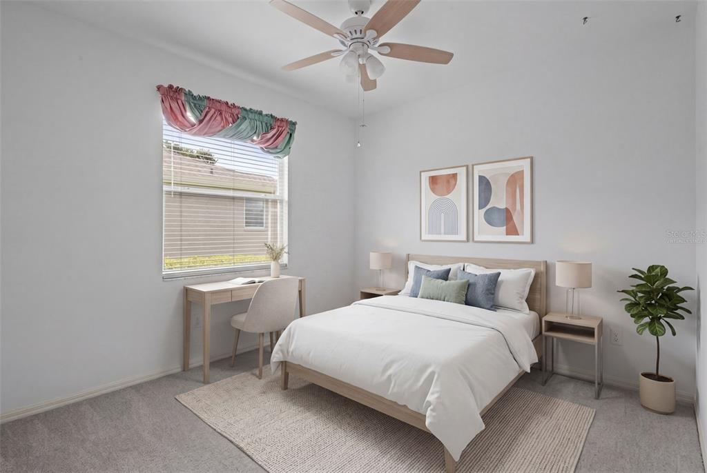 18543 Bittern Avenue Lutz, FL 33558 - Photo 13 of 45 a bedroom with a bed and a potted plant